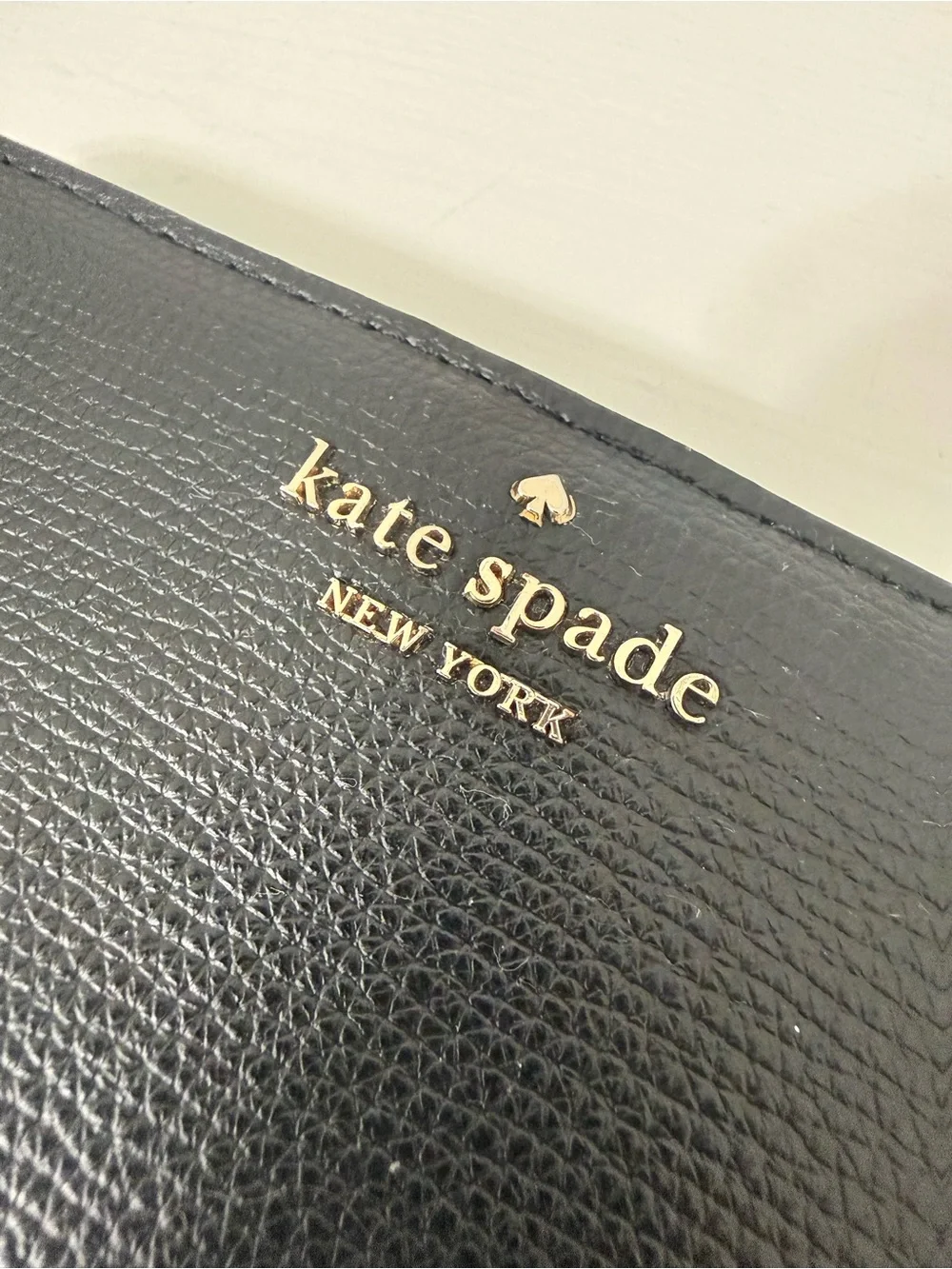 kate spade black leather zip-around continental wallet with gold logo